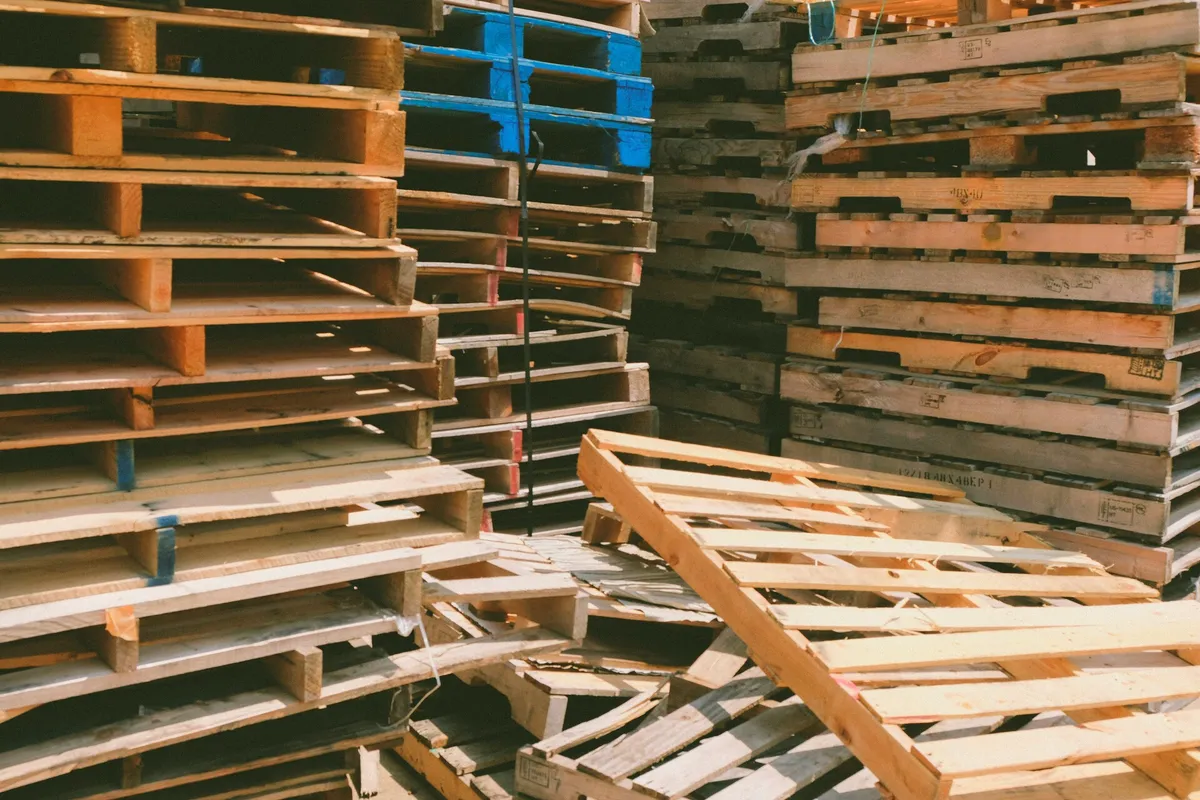 Piles of used wooden pallets ready to be bought and recycled